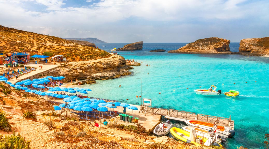 Turquoise lagoon with beach near the Comino island between the islands of Malta and Gozo in the Mediterranean Sea, Europe.